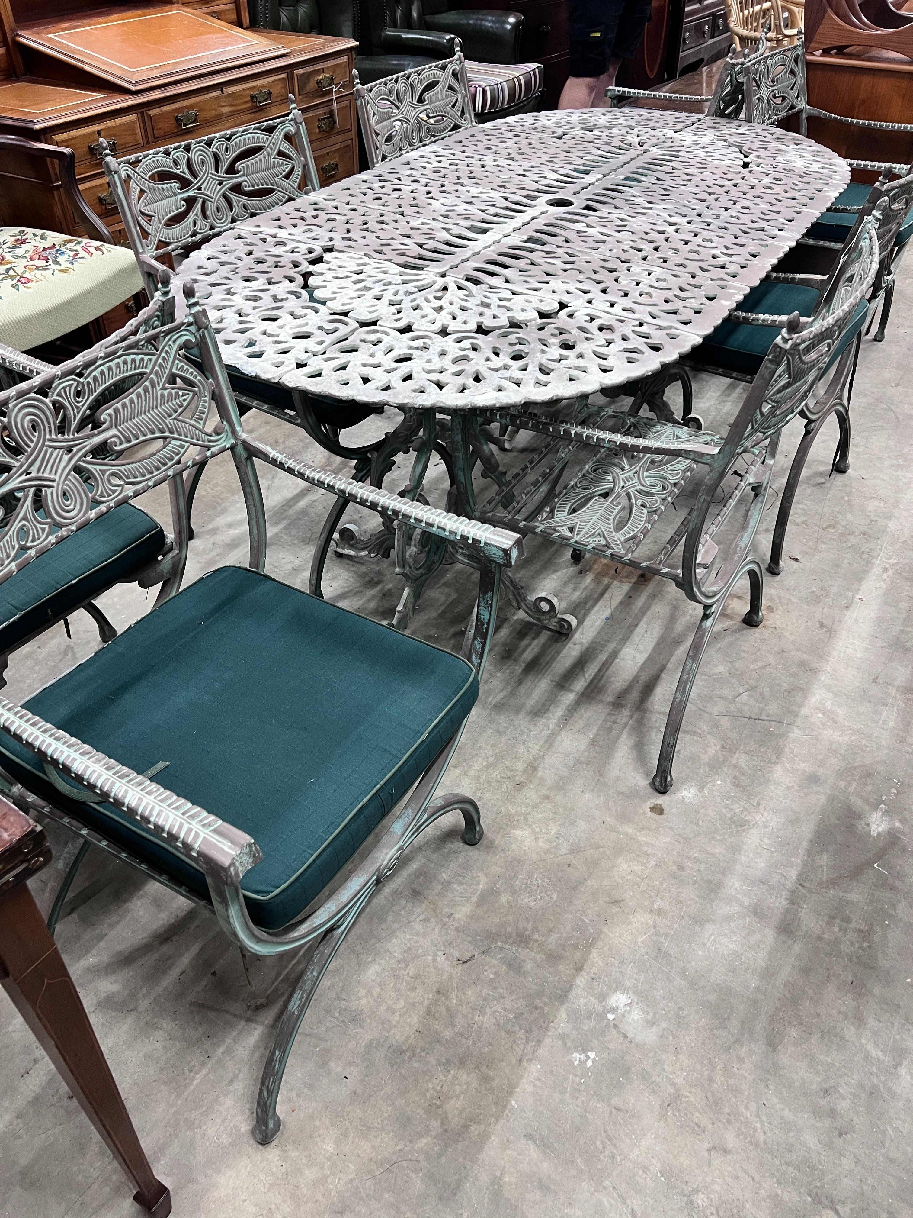 A Victorian style aluminium twin pedestal garden table and eight elbow chairs with seat pads, table length 186cm, width 96cm, height 70cm